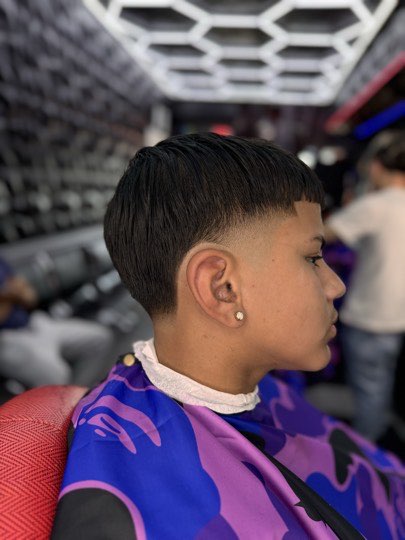 Bowl cut with a straight edge and a taper on the sides.