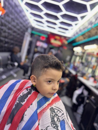 Kid with a spiked top and a skin fade on the sides.