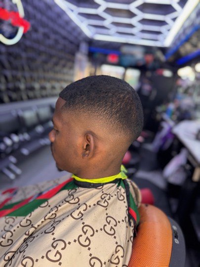 High skin fade with a sharp outline, back view.