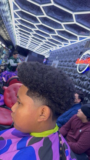 Taper fade with a textured afro on top.