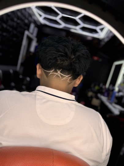 Zigzag shaved with a razor on the nape under textured hair.