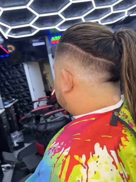 Video: stars shaved with a razor on the side, hair pulled back in a ponytail.